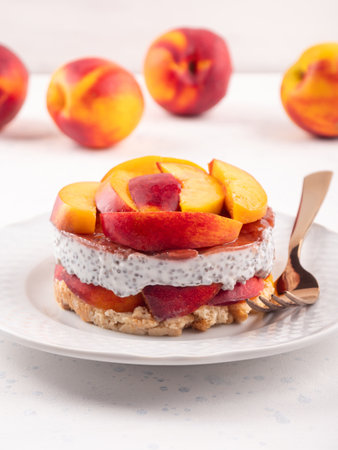 Overnight chia pudding dessert with greek yogurt, peaches and jamの写真素材