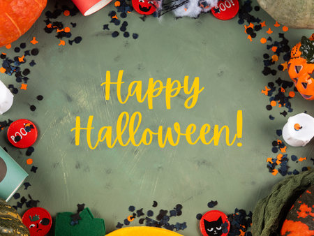 Happy halloween green frame background flatlay with pumpkins and decorの写真素材