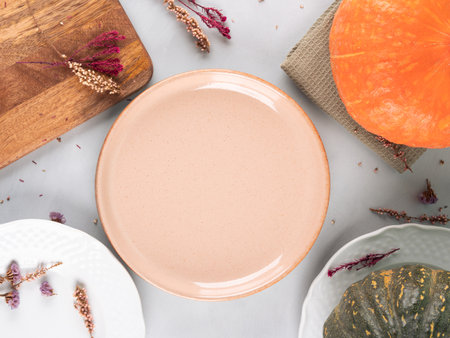 Fall thanksgiving table setting pumpkin decor flatlay with pink dishの写真素材