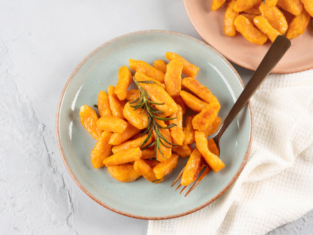Pumpkin recipe homemade gnocchi on pastel color backgroundの写真素材