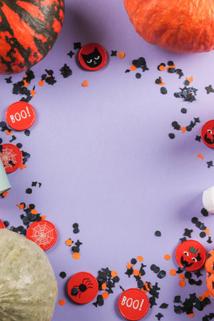 Halloween purple frame background flatlay with pumpkins and party decorの写真素材