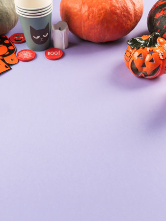 Halloween purple frame background flatlay with pumpkins and party decorの写真素材