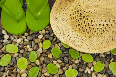 ground gravel pebble with hat and flip flopの写真素材