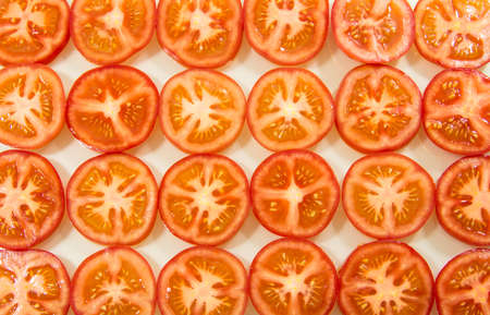 Several tomato slice on white backgroundの写真素材