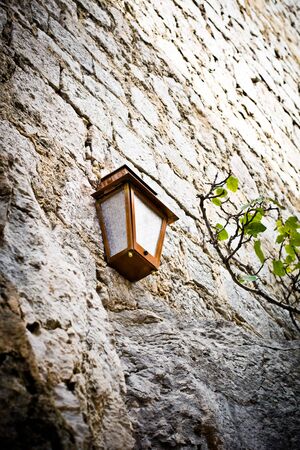 Old lamp in outdoor in a village in southern France
