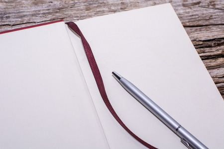 book and pen on wood backgroundの写真素材