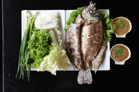 Grilled tilapia salad with chainese noodle,vegetable and spicy sauce. Thai style.の写真素材