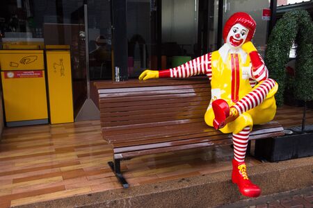 Pattaya,Thailand - July 07,2018 : Photo of Ronald Mcdonald sit on the bench in front of Mcdonald shop n Walking street Pattaya.のeditorial素材