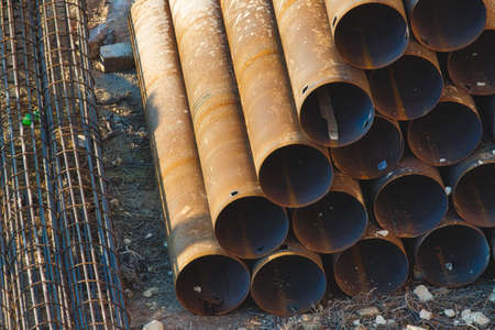 Industrial construction material - pipes stacked in a pyramidの写真素材