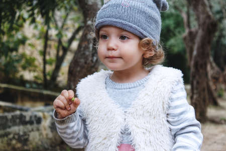 Beautiful young girl model wearing casual winter clothes outdoors in the forest