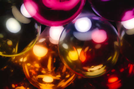 Abstract multi-colored glass light bulbs with a warm glowの写真素材
