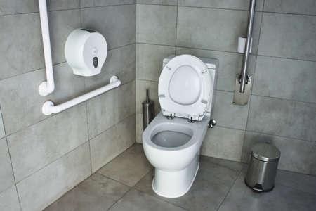 Interior of a disabled restroom with supports on the wallsの写真素材