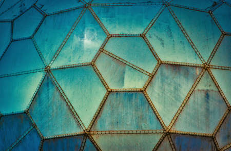 Blue futuristic grungy wall panels made of geometric shapesの写真素材