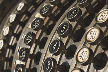 Close-up of numbered buttons on antique cash registerの写真素材