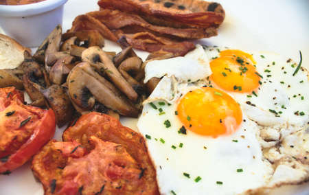 Close-up of full English breakfast on a white plateの写真素材