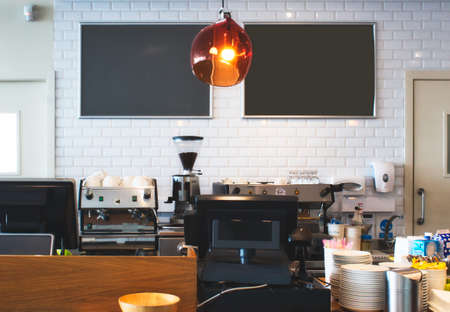 Counter top at a bright cafe with empty blackboards on the wall for copy spaceの写真素材