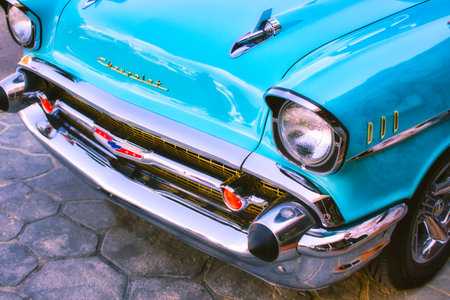 Closeup of the front of an aqua marine blue 1957 Chevrolet 150 with bullet bumper guardsのeditorial素材