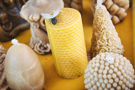 A varied selection of bee's wax candles molded into different elegant shapes and designsの写真素材