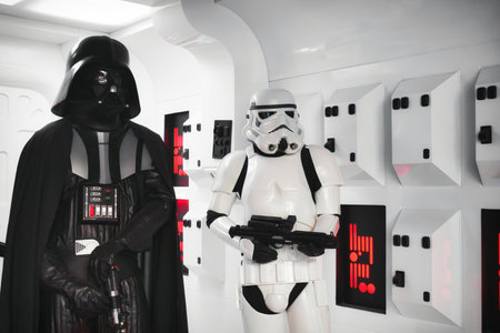 20 May 2023, St. Julians - Malta: Darth Vader and a stormtrooper from the Star Wars movie in full body armor suit costume standing in a spaceship background settingのeditorial素材