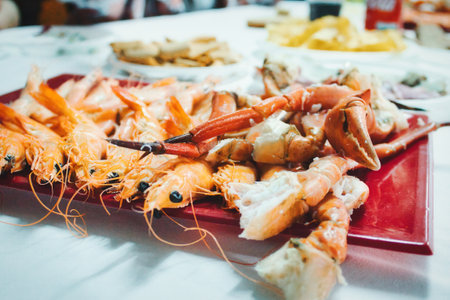 Close-up, wide angle shot of a seafood platter with prawns and crab legs and clawsの写真素材