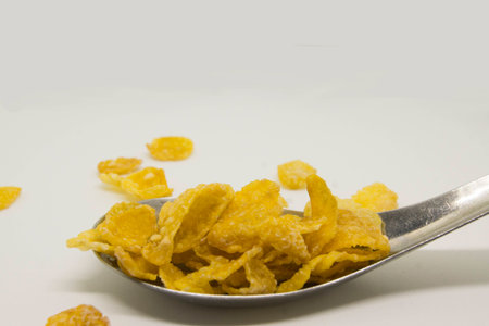 Yellow honey-coat conflakes in the spoon.の写真素材