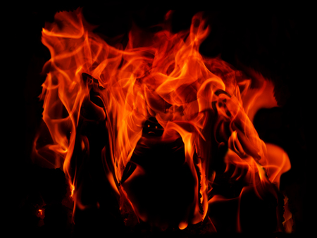 red hot flames on a black background and three silhouettes