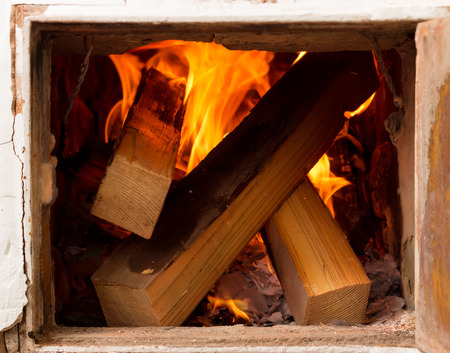 open door, rustic stoves, burning wood and fire. heating homes an alternative methodの写真素材