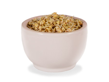 sprouts of green buckwheat in pink bowl. isolated on whiteの写真素材