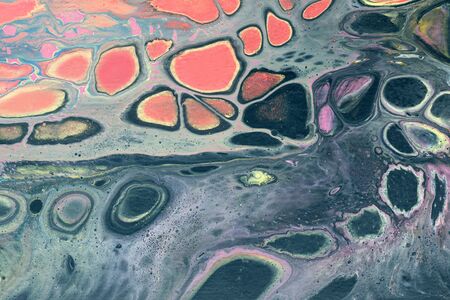 Creative abstract marbling textured background. Mixing red, black, purple and yellow paints....