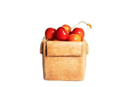 Fresh sweet ripe cherries in a ceramic box isolated on a white background. Side view.の写真素材