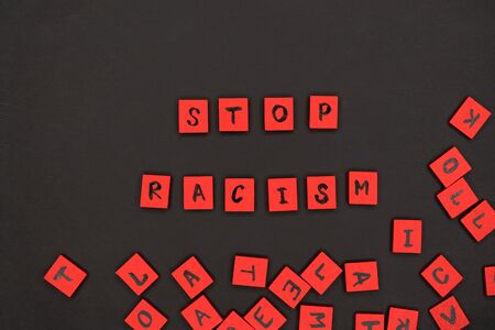 inscription stop racism. protest signs. lettering. red letters on wooden squares on a black background. black lives matter. I can t breathe.の写真素材