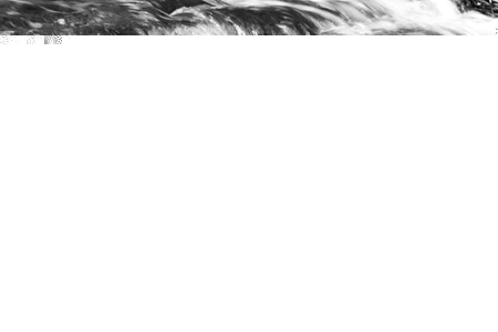 Beautiful background with the moving water of a creekの写真素材