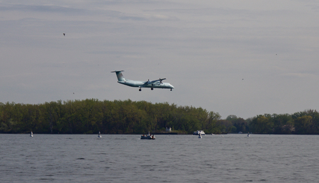 Photo with the landing plane and the boats in the lake