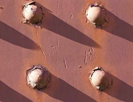 Beautiful pattern on the red sunny metal wall