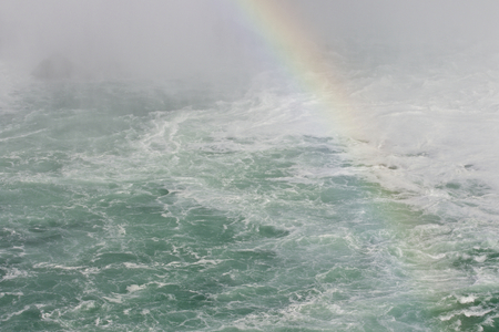 Beautiful photo of the water near amazing Niagara falls with a rainbowの写真素材