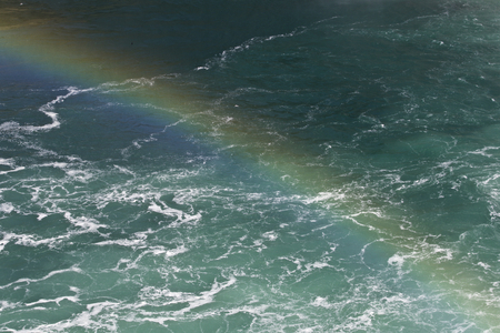 Beautiful photo of the water near amazing Niagara falls with a rainbowの写真素材