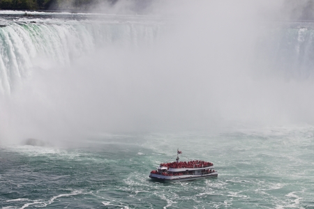 Beautiful photo of a ship near amazing Niagara waterfallの写真素材
