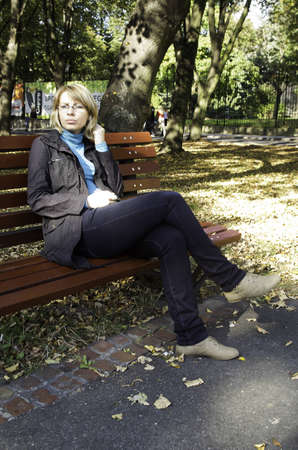 nice woman sitting at the benchのeditorial素材