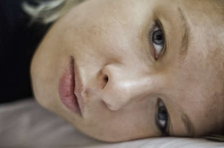 Pretty girl lying and thinkingの写真素材
