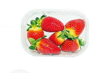 Strawberries in plastic box on white background  の写真素材