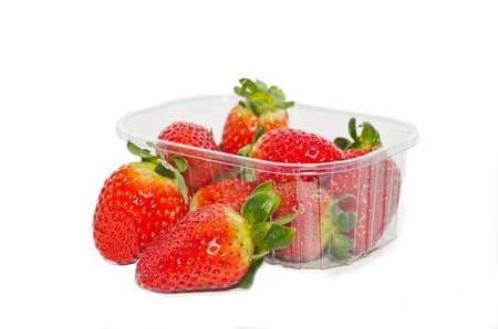Strawberries in plastic box on white background  の写真素材