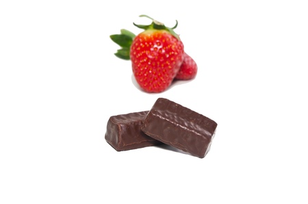 juicy strawberries and chocolate pralines on a white backgroundの写真素材