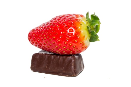 juicy strawberries and chocolate pralines on a white backgroundの写真素材