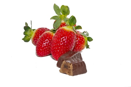 juicy strawberries and chocolate pralines on a white backgroundの写真素材