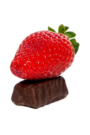 juicy strawberries and chocolate pralines on a white backgroundの写真素材
