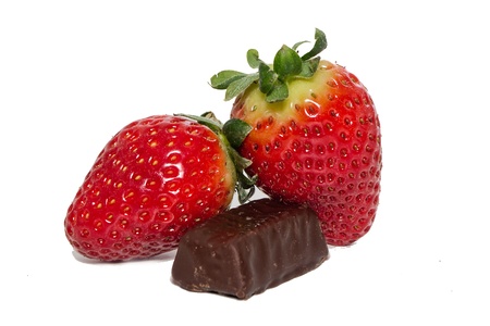juicy strawberries and chocolate pralines on a white backgroundの写真素材