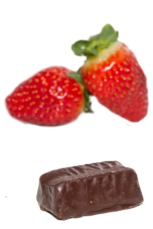 juicy strawberries and chocolate pralines on a white backgroundの写真素材