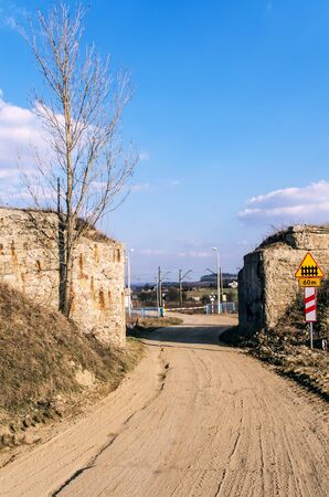 the dirt road and the railway crossingの写真素材