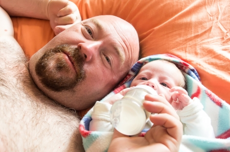 Mature caucasian father feeding his newborn sonの写真素材