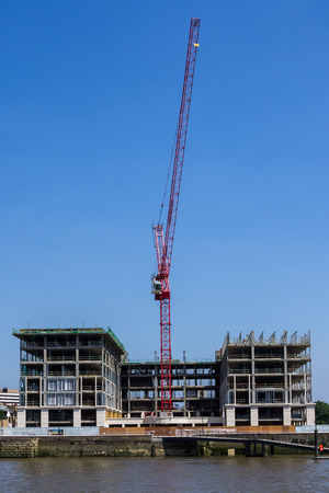 cranes working on a construction site on thamesの写真素材